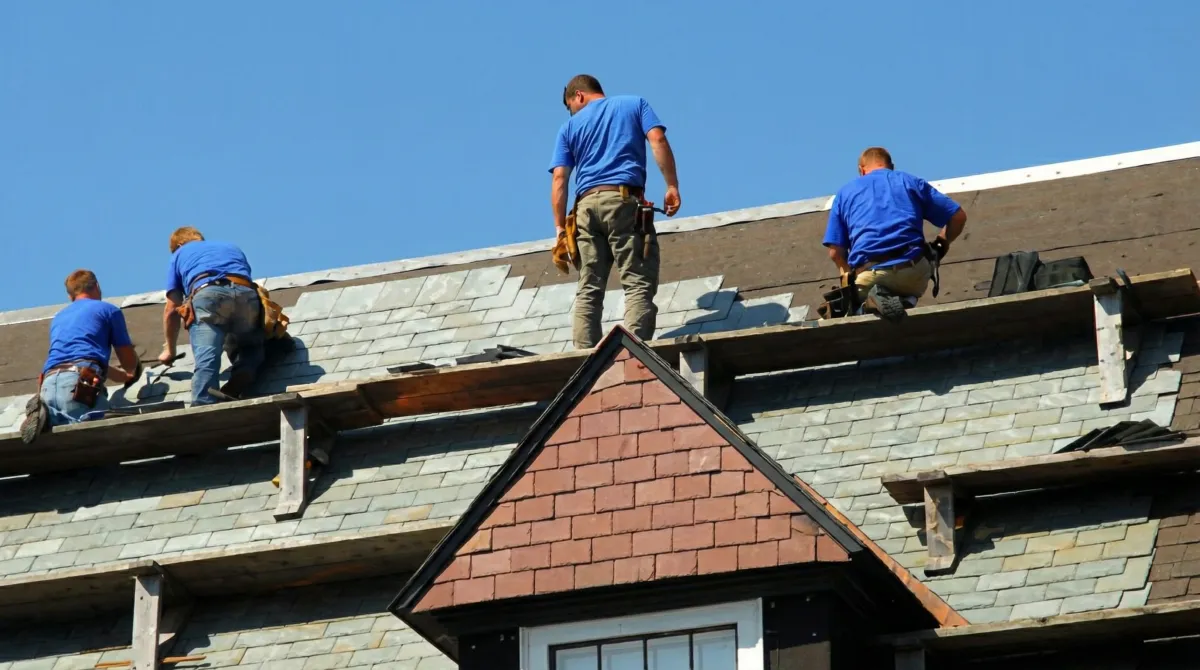 Roof replacement in progress with a team of professional contractors installing new shingles on a residential home in Stockton, CA